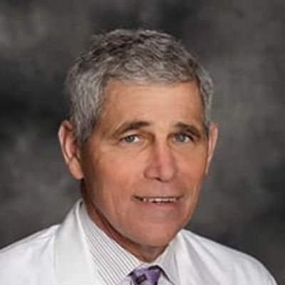 Dr. Kenneth Odinet is wearing a lab coat in the picture.